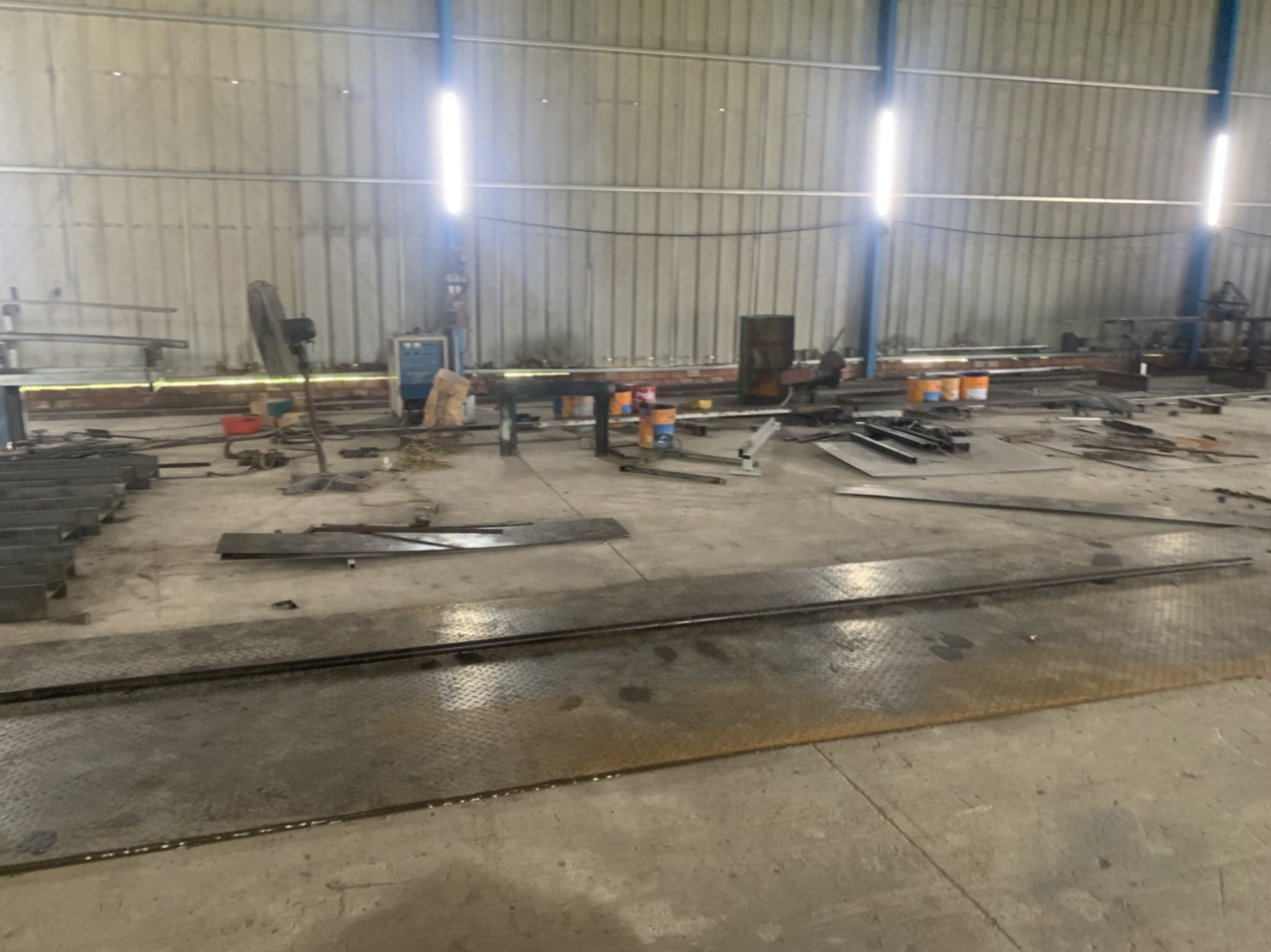 Professional welding workshop with multiple workstations producing custom steel and stainless assemblies